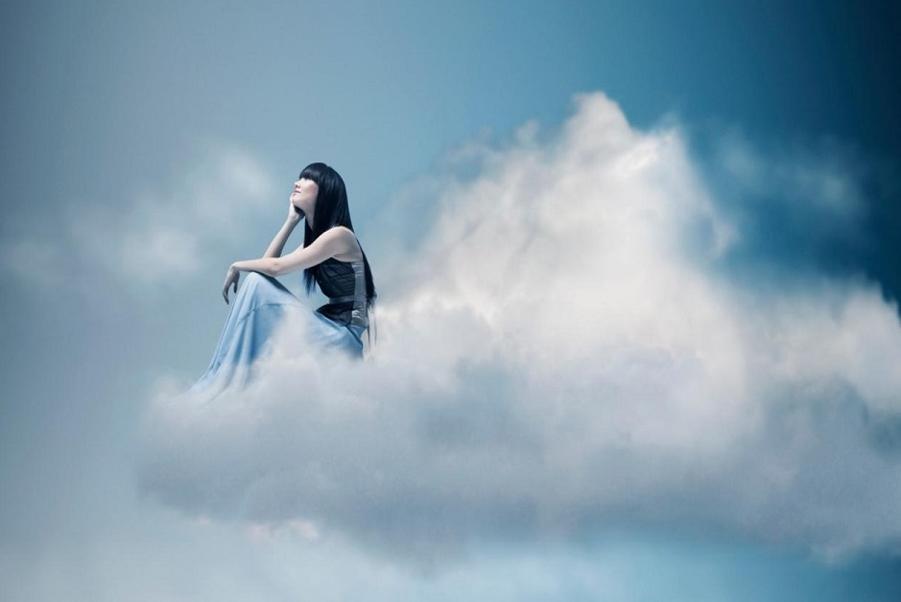 Angels and mediumship concept art with a serene woman in flowing blue surrounded by divine light, symbolizing connection with angels and spirit.