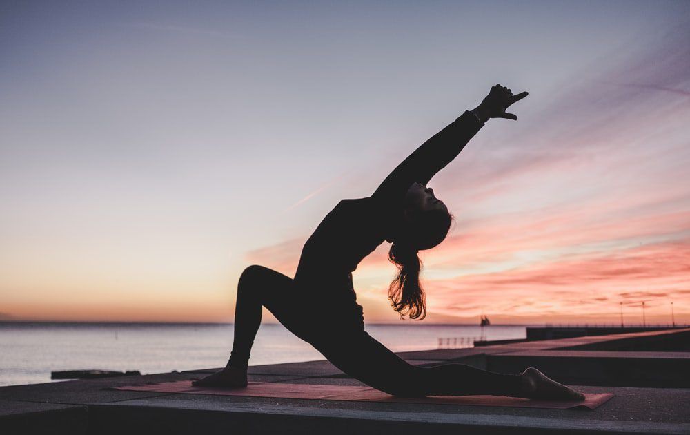 Yoga pose at sunset representing balance, composure, and inner peace
