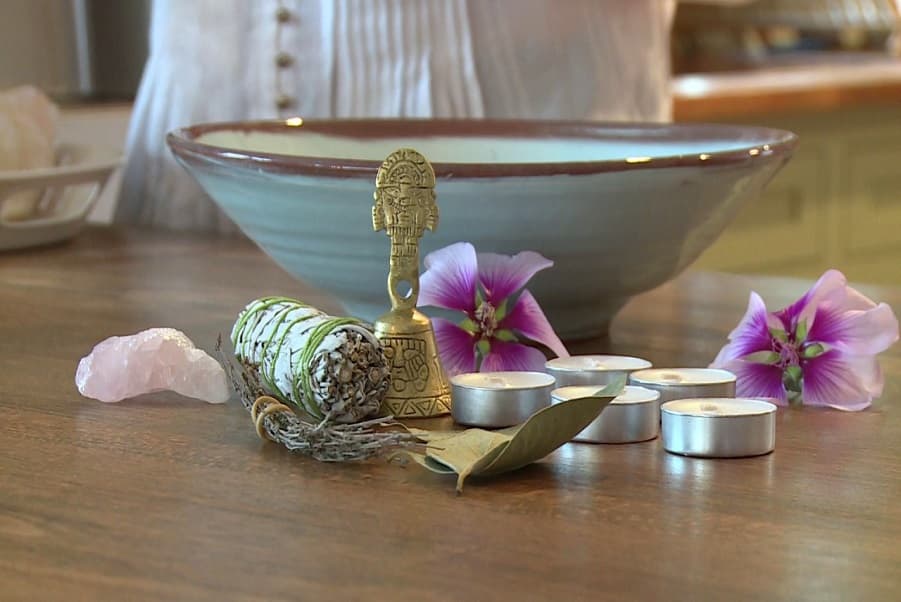 Space clearing altar setup with sage, rose quartz, and sacred tools by Psychic Lilly