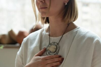 Hand over heart during Reiki healing session for awakening clair senses